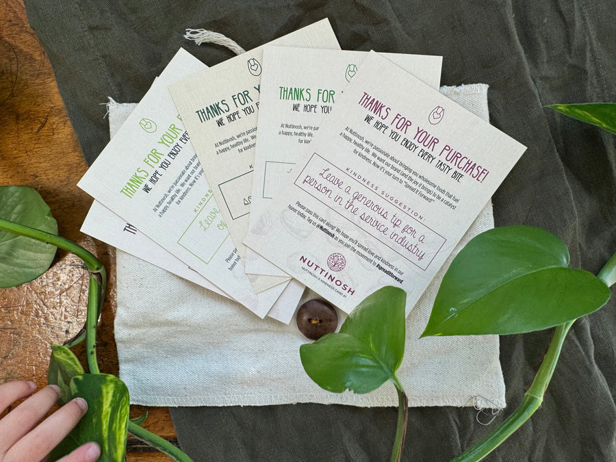 cards displayed on a cloth with plants as decorations