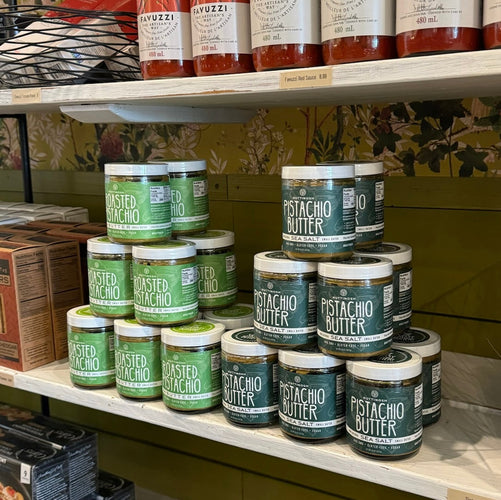 Display of Nuttinosh pistachio butter jars stacked on a store shelf