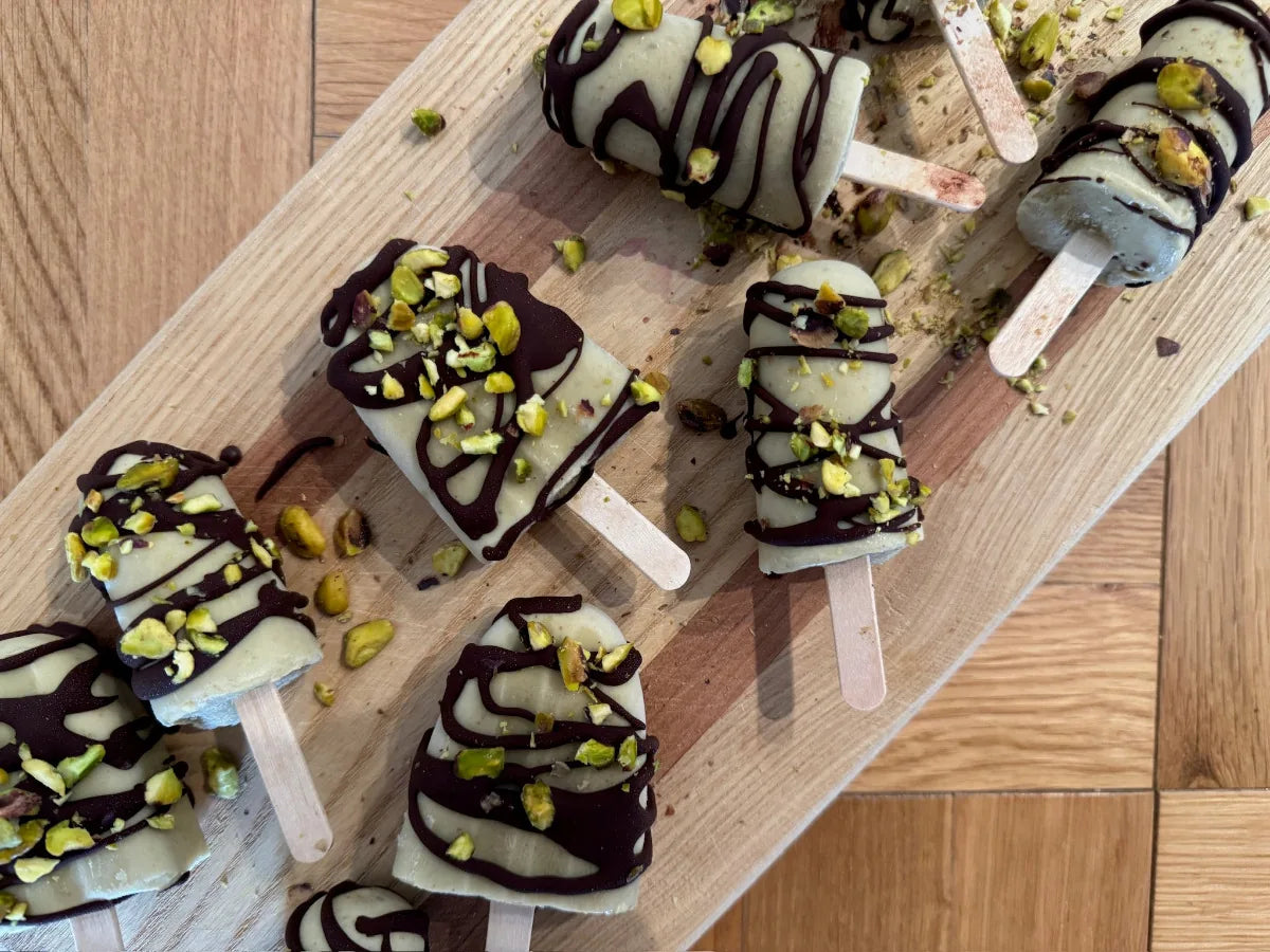 Chocolate-dipped pistachio popsicles topped with chopped pistachios