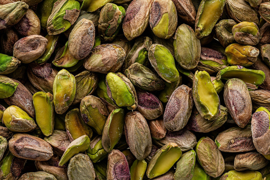 Close-up of fresh pistachios in shells with vibrant kernels visible