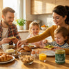 Family enjoying breakfast while spreading Nuttinosh pistachio butter with sea salt on toast at the kitchen table