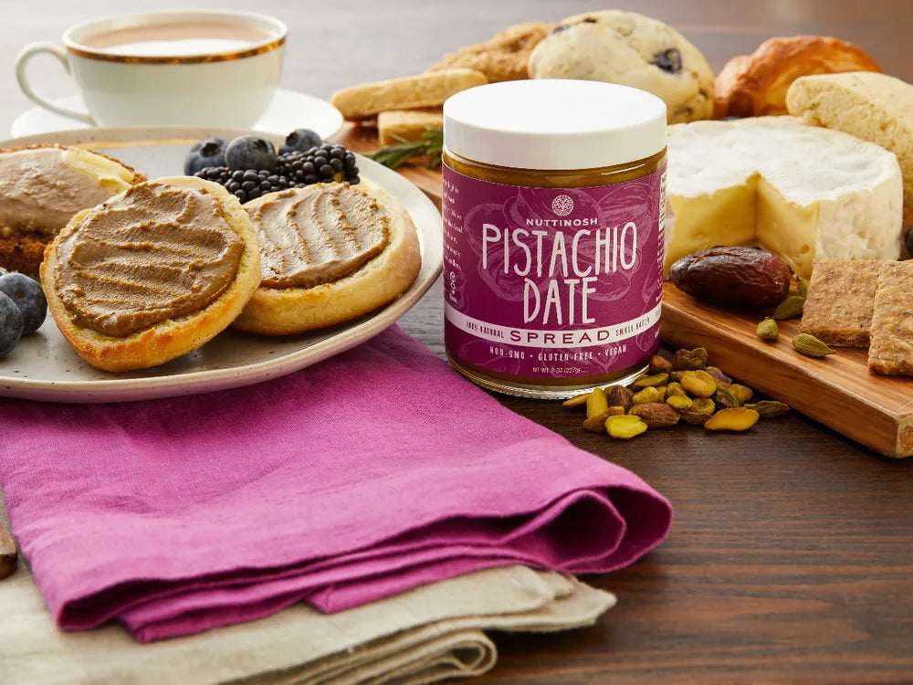 Nuttinosh pistachio date butter with toast, fruit, cheese, and breakfast pastries