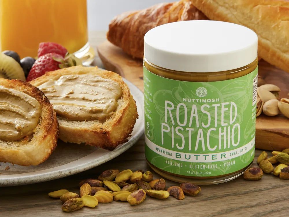 Nuttinosh pistachio date butter with toast, fruit, cheese, and breakfast pastries